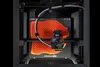 Prusa CORE One+ in use: close-up of the enclosed printer actively printing.