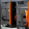 Prusa CORE One+ printer farm / multiple-printer context image.