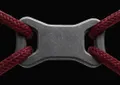 Close-up context image of a matte carbon-fiber PET-CF printed rope connector under load.